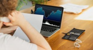 Man reviewing finances on computer monitor